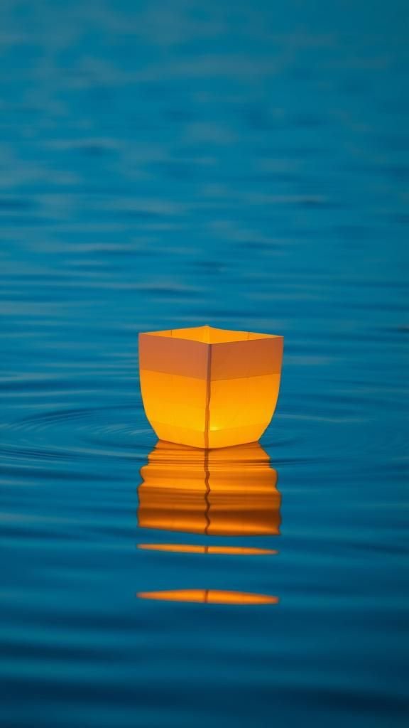 Floating lanterns that mimic soft water reflections