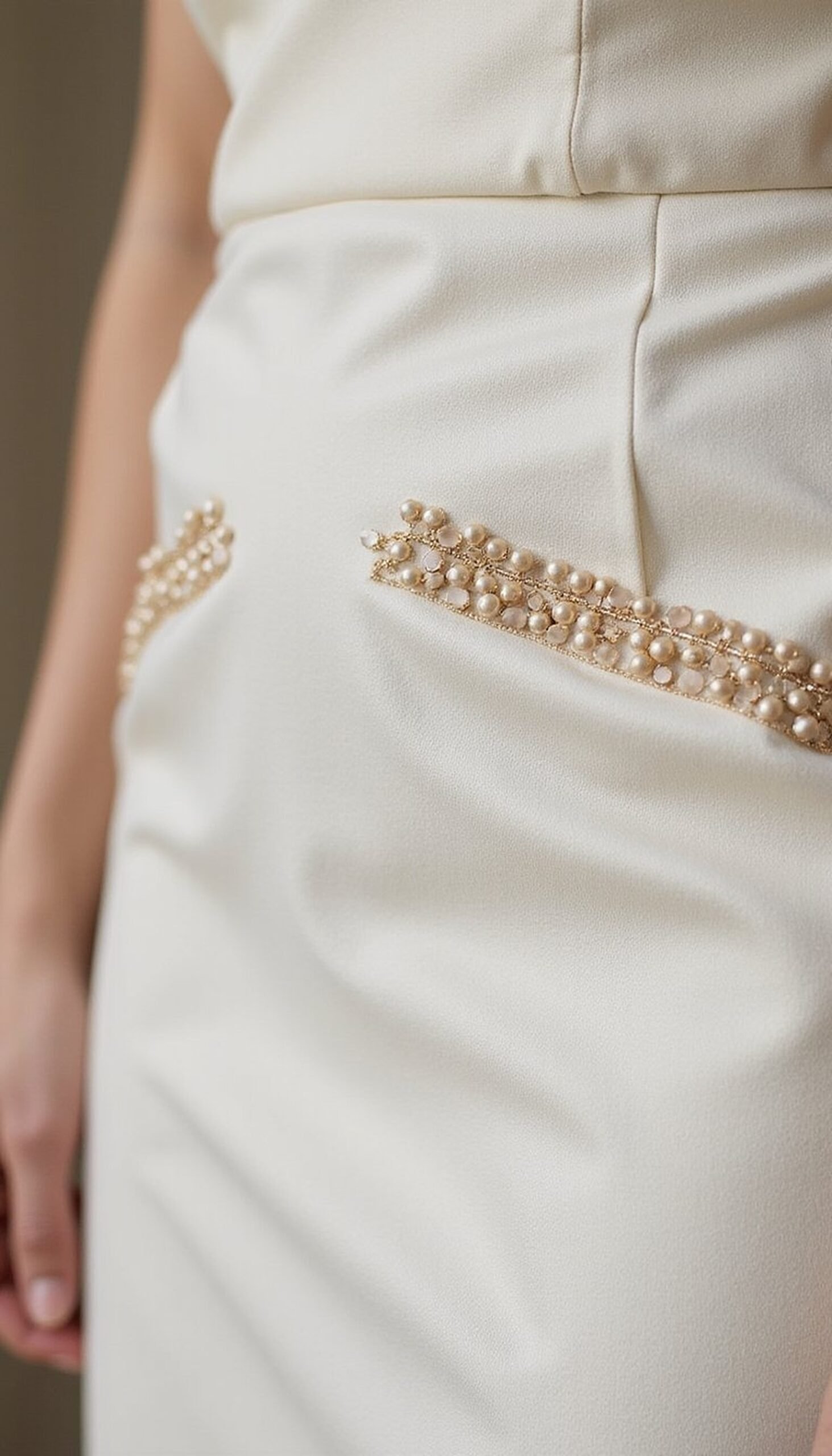 Hand-stitched bead trim on sheath hem